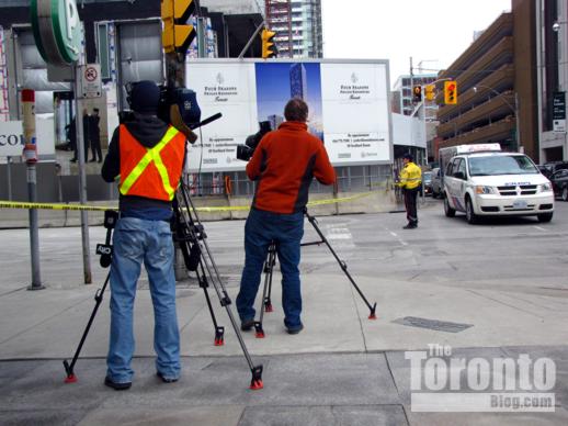 Television cameramen filming outside the Four Seasons construction site 